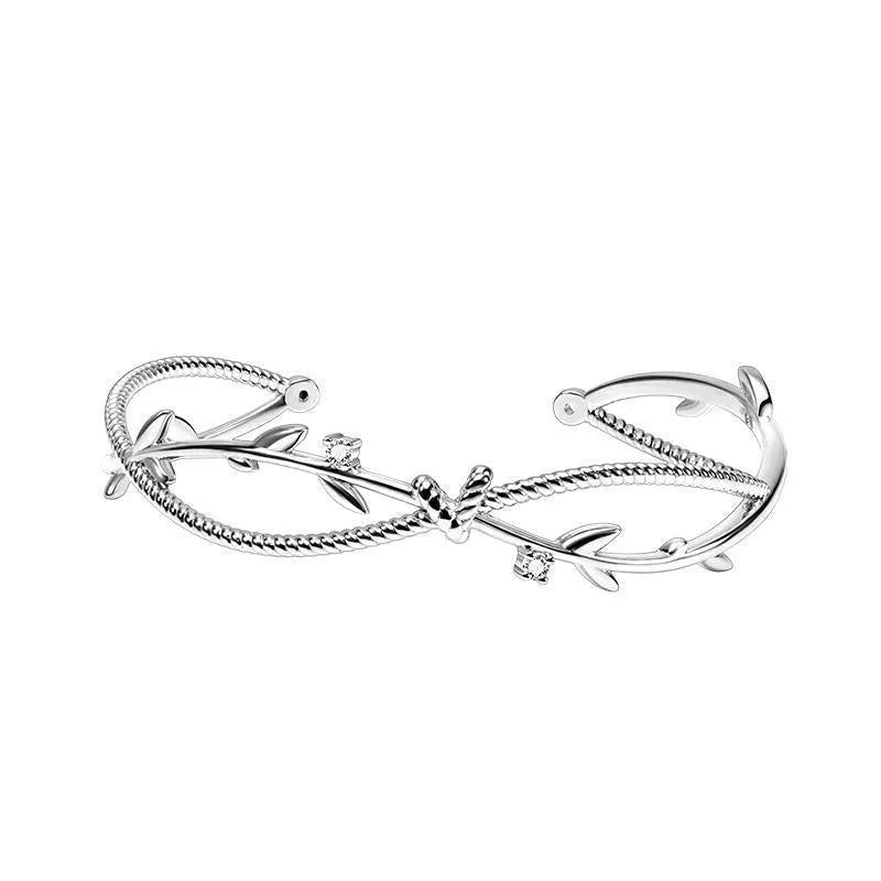 Copper ins style bracelet with detailed young tree branch and sprout cross twisted design in electroplated white gold colour.