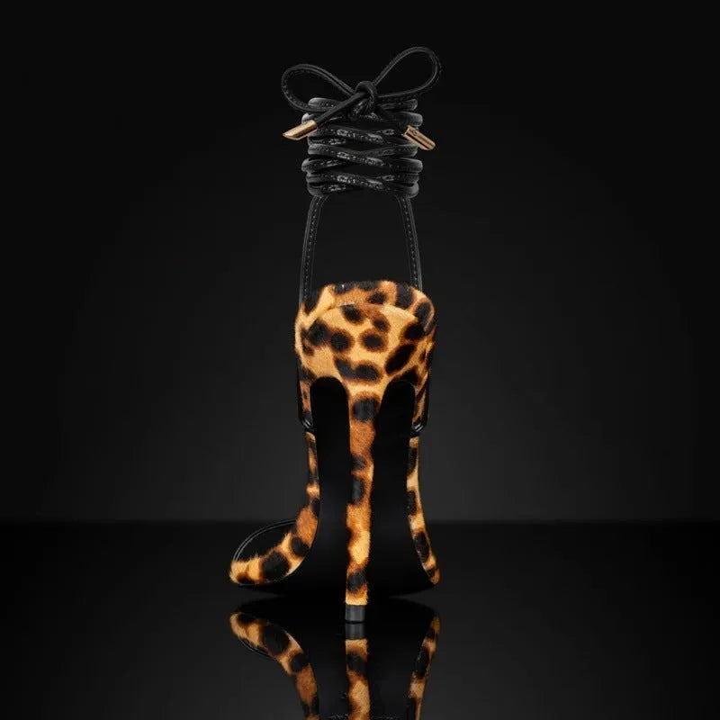 Leopard print women's Roman sandals with pointed toe and lace-up buckle closure on a rubber sole