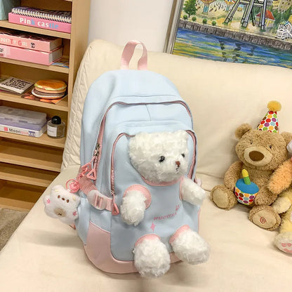 Macaron colour nylon school backpack with curved straps, shown in yellow pink, with a pendant attached.