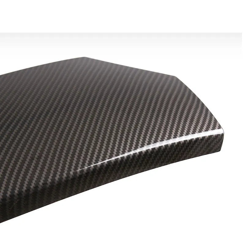Set of three black ABS armrest box covers with a diagonal carbon fibre weave pattern and polished surface.