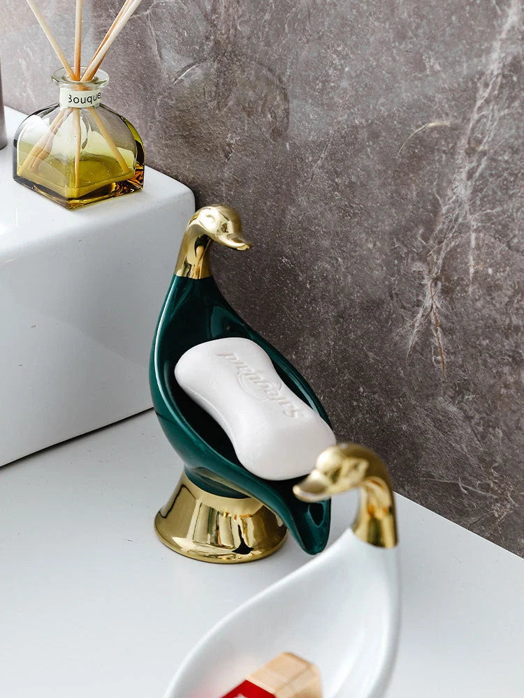 Ceramic swan soap rack in white and green, featuring a drainage cover