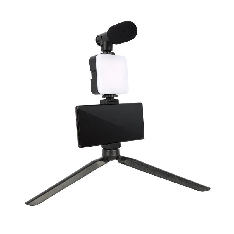 Square LED camera flash with universal hot shoe mount and rotatable head, shown with optional octopus stand tripod.