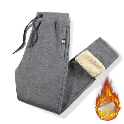 Men's grey fleece-lined cotton track pants with an elasticated waist, shown in an oversized fit.