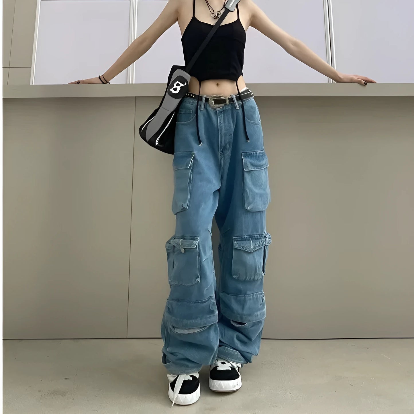 Blue high waist wide leg denim trousers with multiple pockets on a mannequin