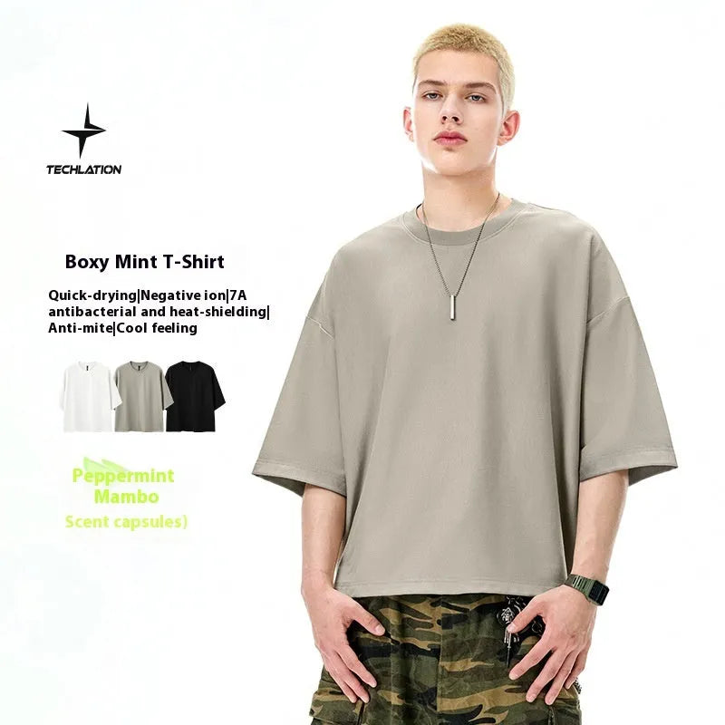 Men's technology cool quick-drying short sleeve T-shirt pullover in sand grey or black colours available in sizes M, L, and XL made from 59.75% cotton and 40.25% polyester fibre blend fabric with a loose regular fit designed for leisure wear