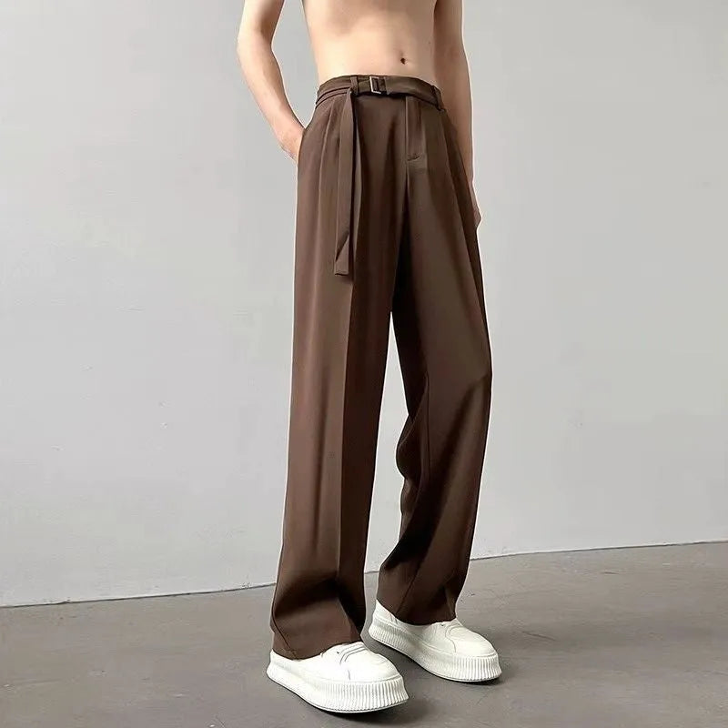 A pair of black straight leg wide fit women's trousers with a loose, casual silhouette on a hanger.