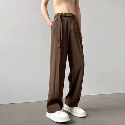 A pair of black straight leg wide fit women's trousers with a loose, casual silhouette on a hanger.