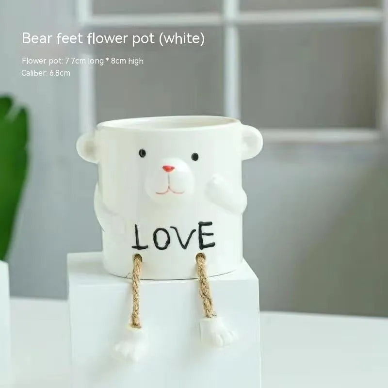 Ceramic hanging foot flowerpot with cartoon design for succulents on desktop
