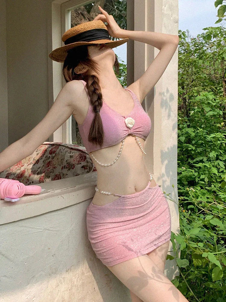 Pink and black polyester three-piece bikini swimsuit on a mannequin