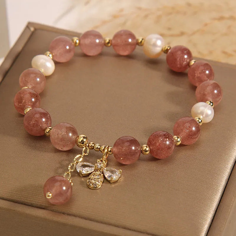 Women's adjustable bracelet with freshwater pearls, strawberry quartz stones, and bee charm