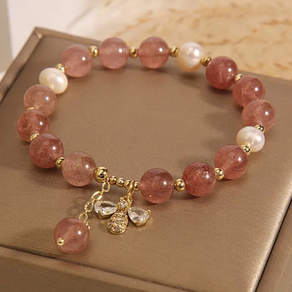 Women's adjustable bracelet with freshwater pearls, strawberry quartz stones, and bee charm