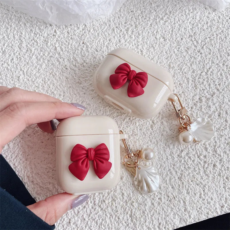 Beige red bow shell patterned TPU clamshell protective case for AirPods Pro earphones.