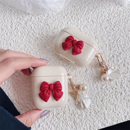 Beige red bow shell patterned TPU clamshell protective case for AirPods Pro earphones.