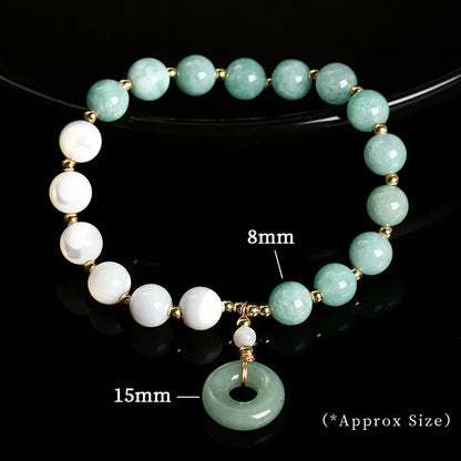 Blue Burma jade bead bracelet with copper horseshoe screw safety buckle on a wrist.