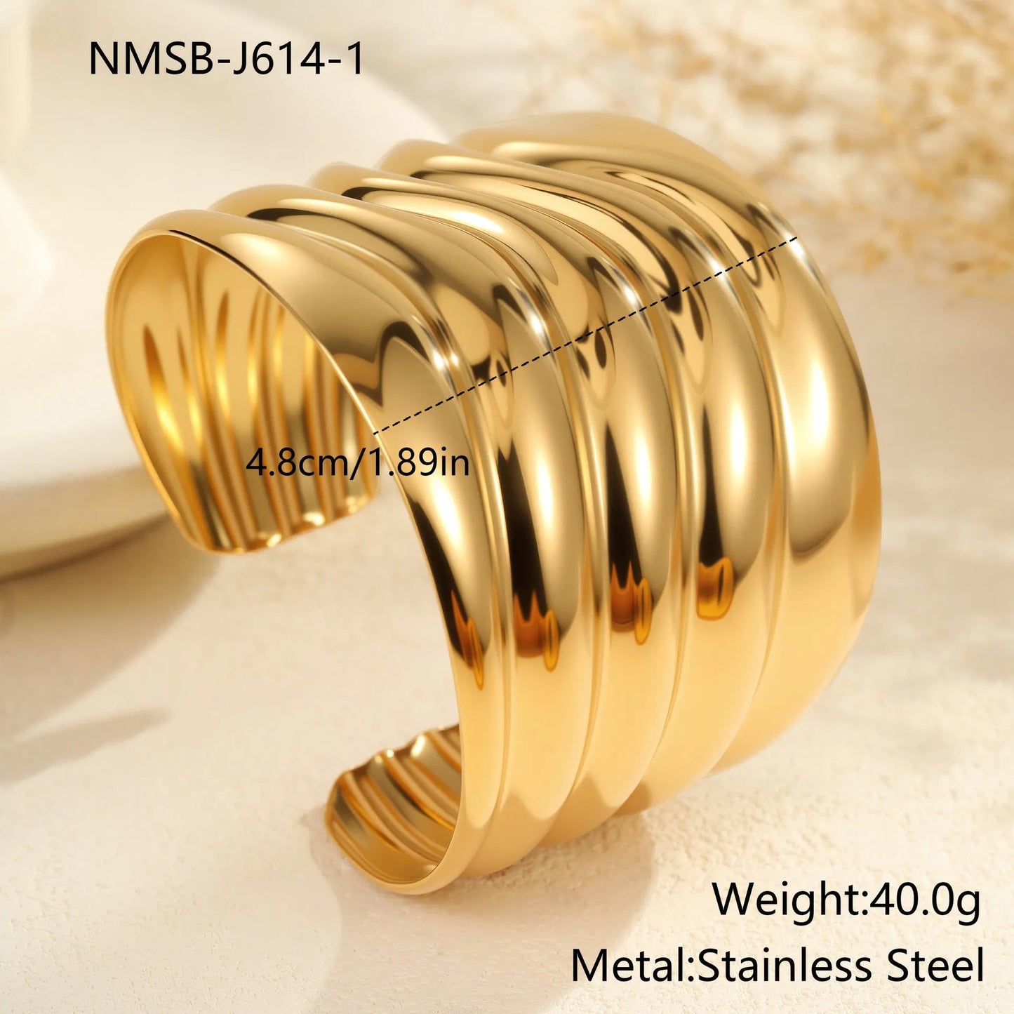 Women's stainless steel bracelet with 18K gold plating featuring exaggerated wide geometric wave design and niche opening