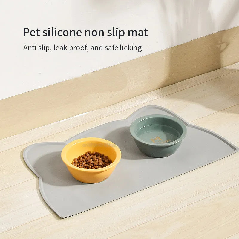 Solid-colour silicone pet feeding mat with cat head design measuring 44 by 24 centimetres