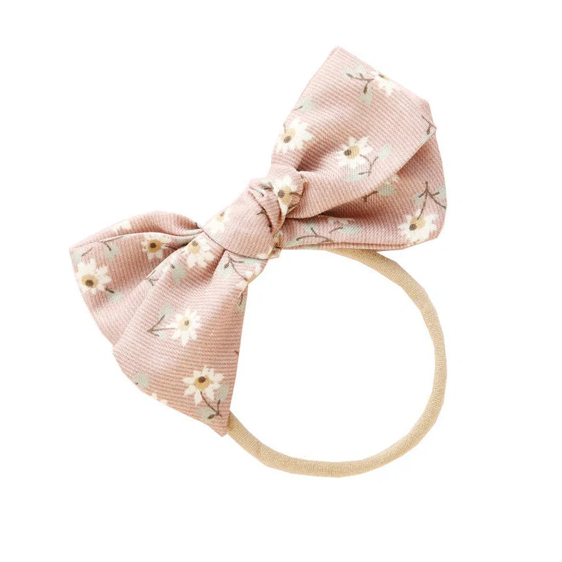 Children's cloth hair band with knotted bow design in one of six colour options