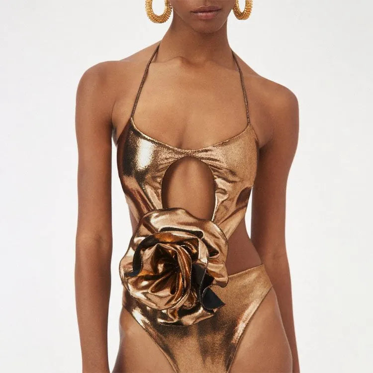 Gold handmade halter one-piece swimsuit with hollow out floral pattern on a mannequin.