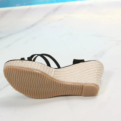 Women's black wedge sandals with a fish mouth toe bracket and fabric upper.