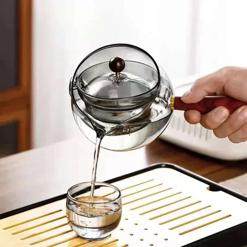 Semi-automatic rotary glass teapot with integrated infuser and wooden handle for manual brewing control, suitable for office and home kitchen use with heat-resistant borosilicate glass construction