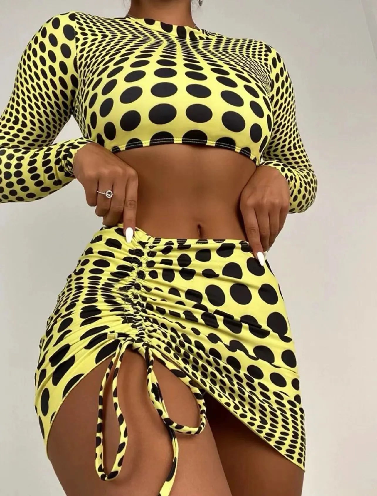 Women's green polka dot three-piece swimsuit set showing top, skirt, and bra