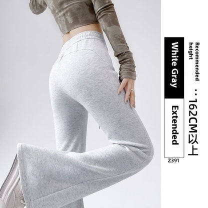 Women's high waist bootcut sports pants in black cotton with fleece lining and micro elasticity, slightly flared leg.