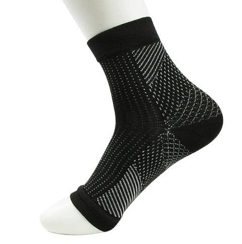 Anti-fatigue compression foot sleeve in black, red, or white, featuring moisture-wicking fabric and a heel hole for breathability.
