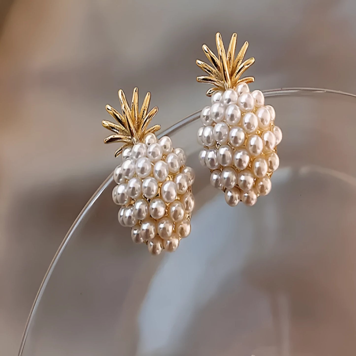 Korean style pineapple and starfish motif earrings with pearl accents in gold, silver, pearl flower, or starfish pearl finish.