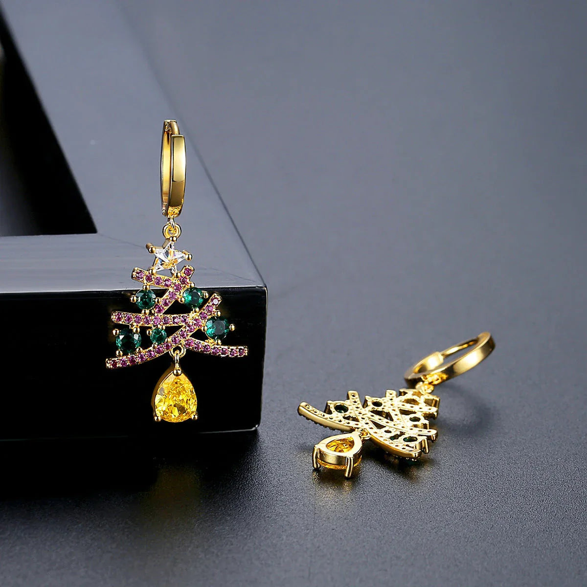 Shimmering gold Christmas tree earrings with colorful rhinestones, a must-have holiday fashion accessory