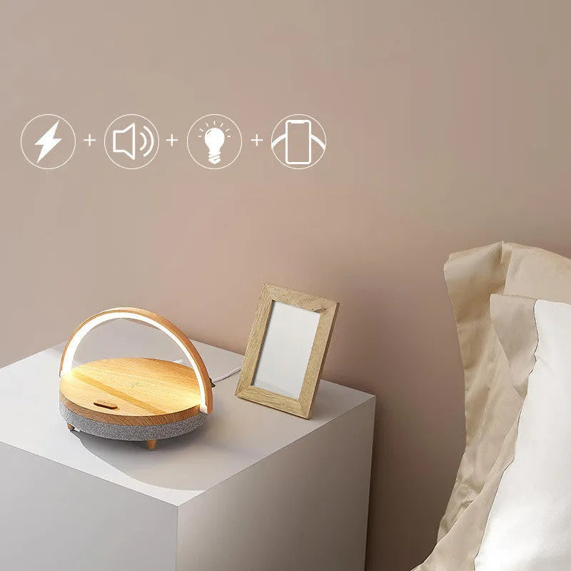 Wireless charging LED night light with Bluetooth speaker in marble pattern finish on bedside table