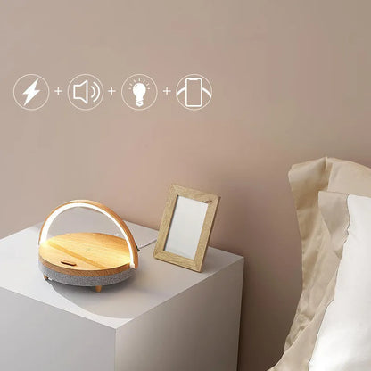 Wireless charging LED night light with Bluetooth speaker in marble pattern finish on bedside table