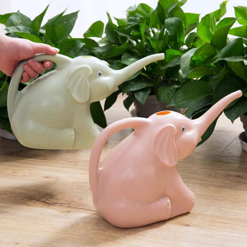 A pink children's elephant-shaped watering can with a long nozzle and baby bottle handle for gardening.