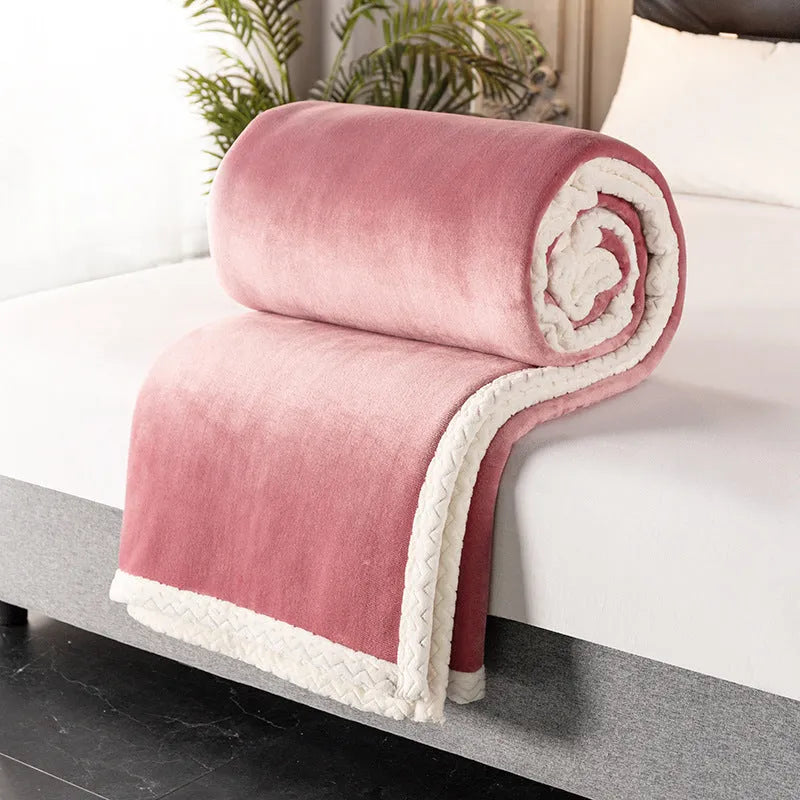 A thick, plain coral fleece blanket in a choice of colours, folded to show its texture.