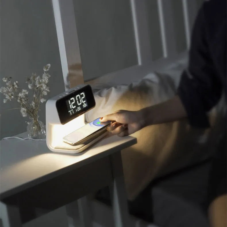White 3-in-1 bedside lamp with wireless charging pad, LCD alarm clock screen, and touch controls.