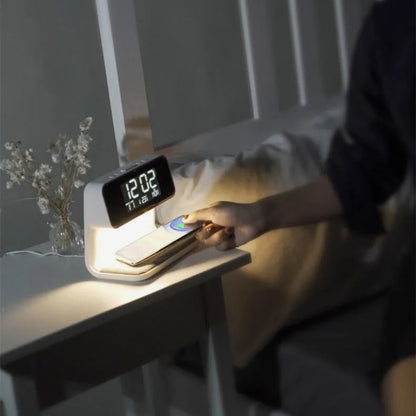 White 3-in-1 bedside lamp with wireless charging pad, LCD alarm clock screen, and touch controls.
