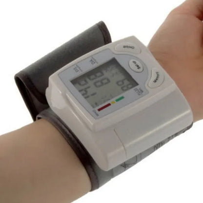 Grey portable wrist blood pressure monitor with digital display and ABS plastic casing