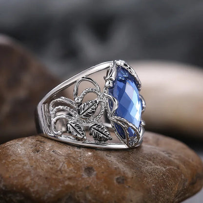 Blue horse eye-shaped crystal ring in alloy metal with geometric design on finger