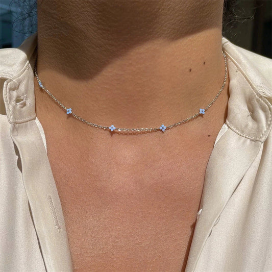 Elegant gold and silver floral necklace with adjustable chain and flower charm, perfect for vacation and beach outfits