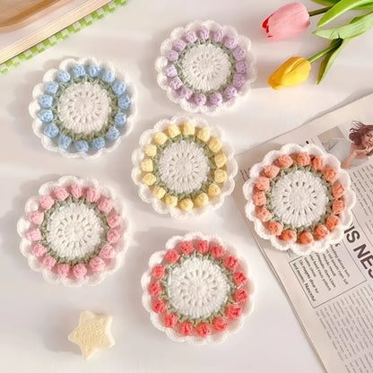 Handmade woven floral coaster in cotton and linen, showing pink, purple, red, and yellow colour options