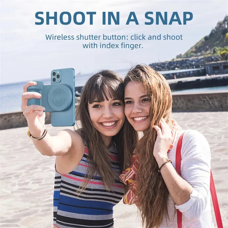 Black magnetic phone camera grip with rotatable bracket and ergonomic PU leather handle on a table.