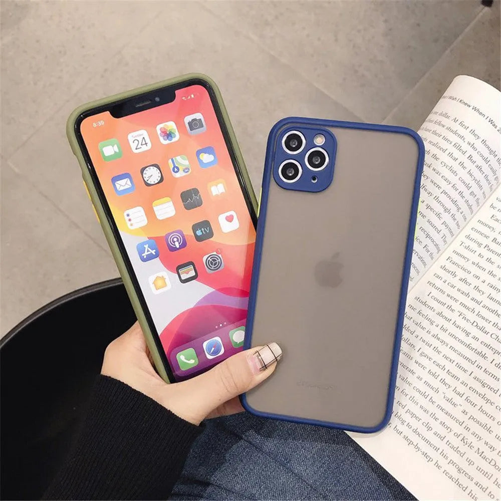 Solid colour silicone shockproof protective case for iPhone models on a table.
