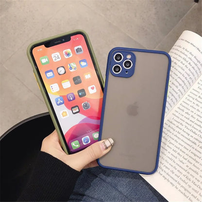 Solid colour silicone shockproof protective case for iPhone models on a table.