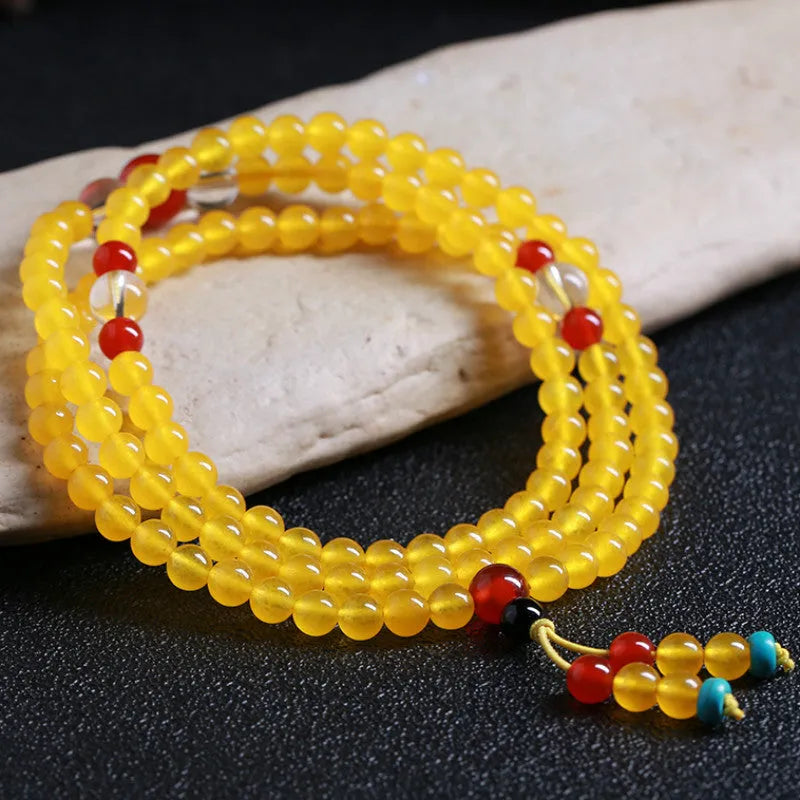 Crystal canary stone 108-bead necklace and bracelet set with geometric beads and lucky cat charm.