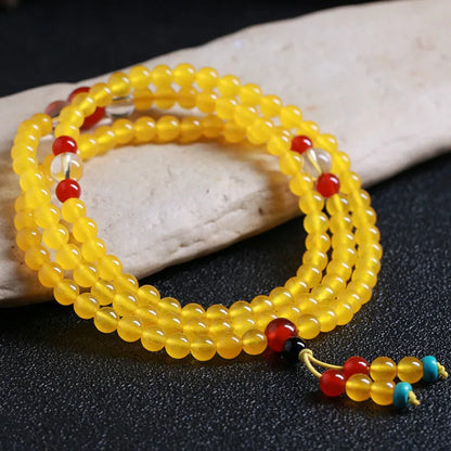 Crystal canary stone 108-bead necklace and bracelet set with geometric beads and lucky cat charm.