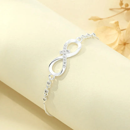 Diamond studded pull-out bracelet with infinite 8-shaped design, copper plastic, 26cm circumference, 20.0mm x 8.0mm