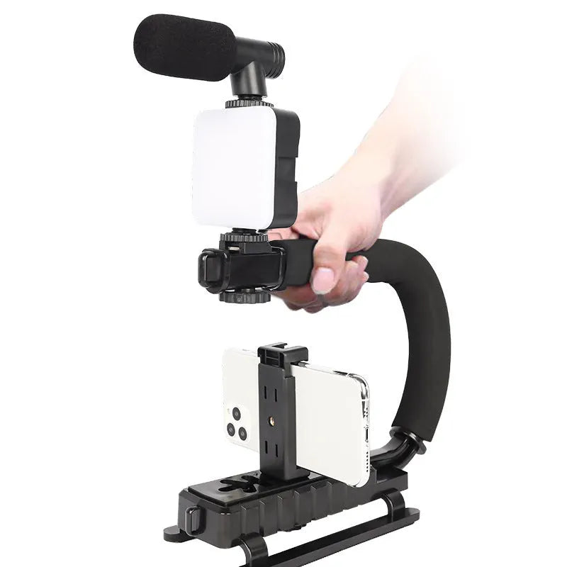 Square LED camera flash with universal hot shoe mount and rotatable head, shown with optional octopus stand tripod.