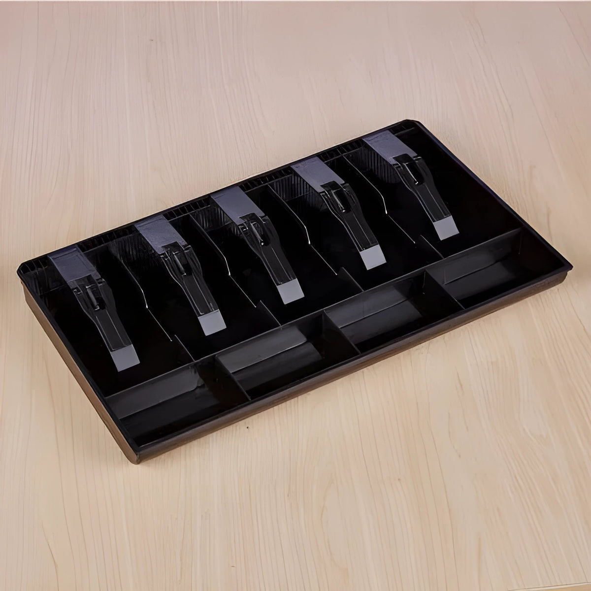Black and white five-drawer ABS plastic cash register box for organising banknotes and coins.