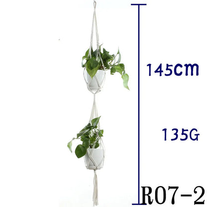 Handmade beige cotton rope net bag holding a plant pot, showing its textured sling design.
