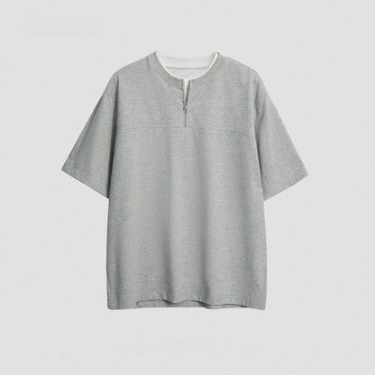 Solid colour loose fit cotton blend pullover top with patchwork collage detailing on a model.