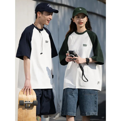 Men's blue loose-fit Japanese style long sleeve t-shirt with raglan sleeves on a hanger.